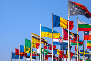 Lots of national flags blowing in front of the UN building. 