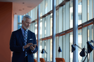 Company executive looks at information on phone. 