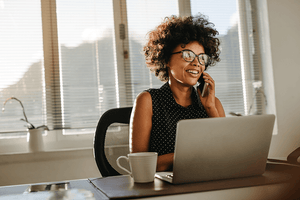 Human resource professional discusses business concerns on telephone. 