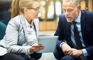 Two executive team members reviewing their quarterly report