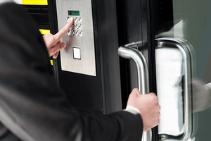 Man entering secure building using password.