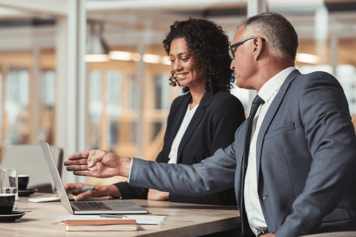 Human resource managers discussing stats on the computer