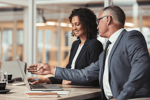 Human resource managers discussing stats on the computer