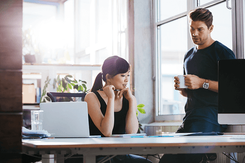 Two professionals examining paperwork