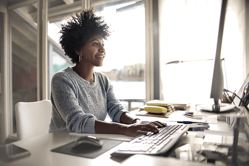 Woman inputting records into her desktop